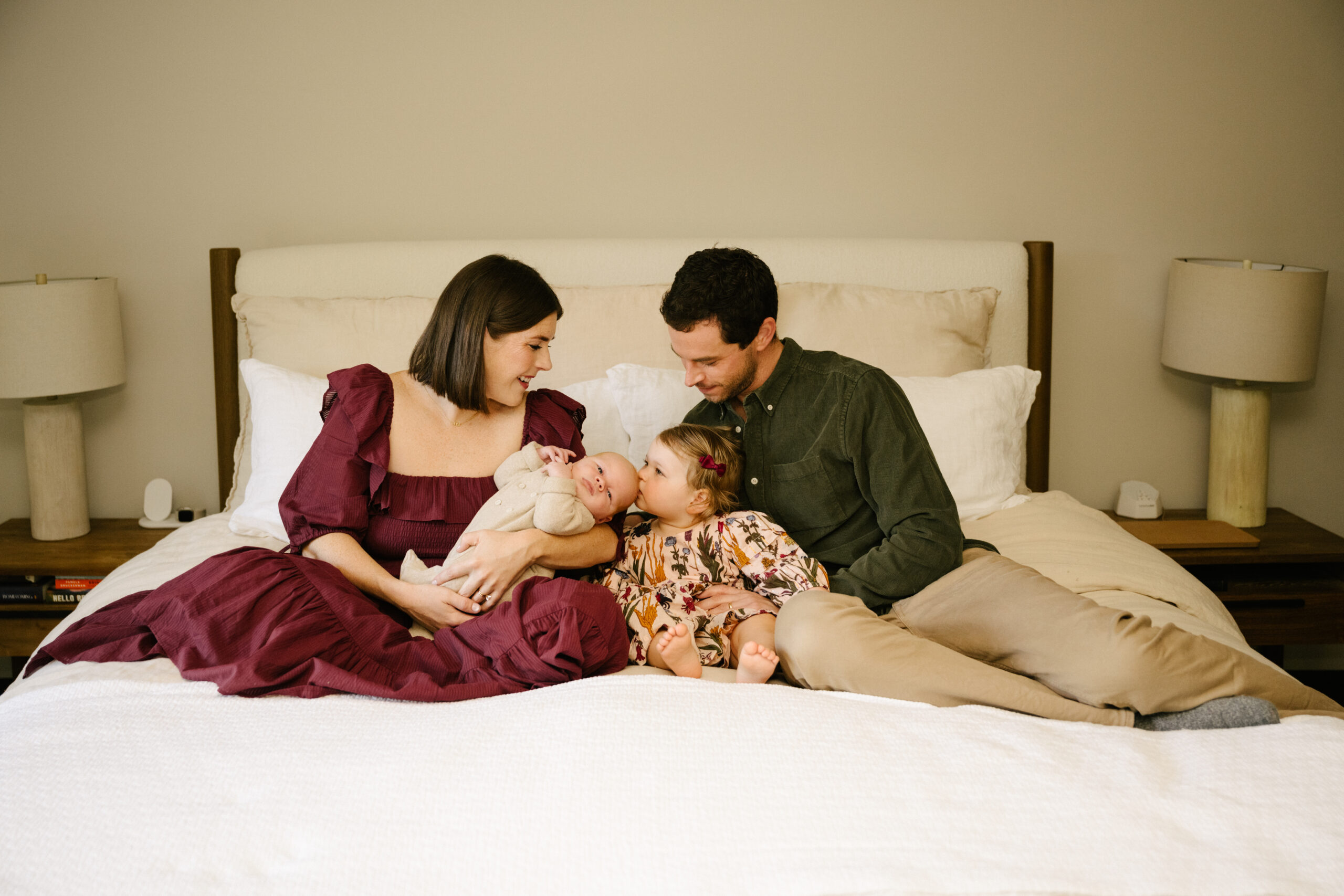 family in bedroom with baby boy